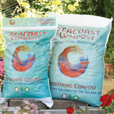 Two bags of SeaCoast Compost, a biodynamic compost, in front of flowers.