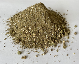 Close-up pile of dry KIS Organics Nutrient Pack showing coarse organic meal and mineral texture.