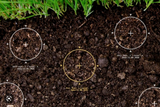 Soil testing analysis graphic showing sampling target zones and soil data overlays on rich organic soil.